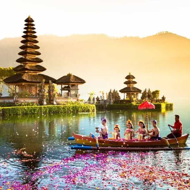 People enjoying Balinese festival boating in Ulun Danu Beratan lake in Bali