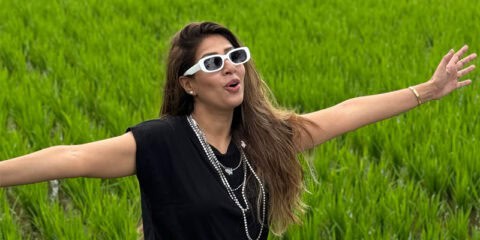 Beautiful woman enjoying Bali rice fields during group tour.