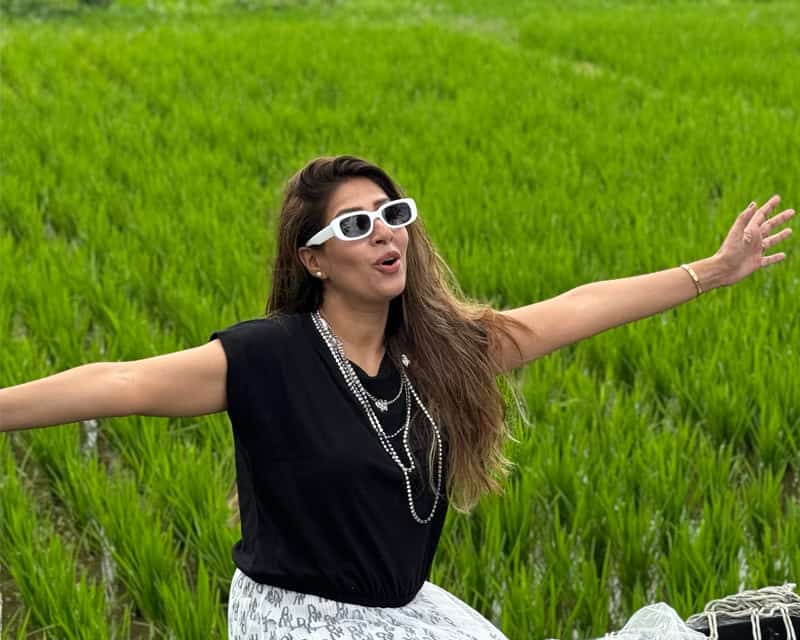 Beautiful woman enjoying Bali rice fields during group tour.