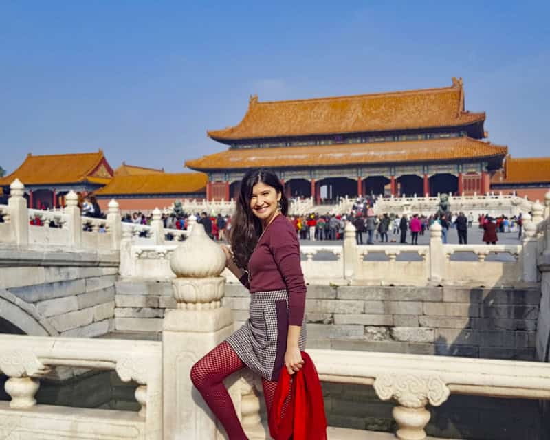 Tourist girl posing at ancient Imperial city of China in Beijing