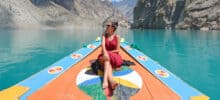 Foreigner tourist girl boating in Attabad lake, Hunza valley - Gilgit Baltistan in Pakistan