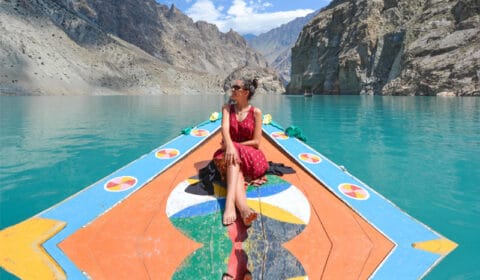 Foreigner tourist girl boating in Attabad lake, Hunza valley - Gilgit Baltistan in Pakistan