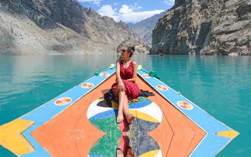 Foreigner tourist girl boating in Attabad lake, Hunza valley - Gilgit Baltistan in Pakistan