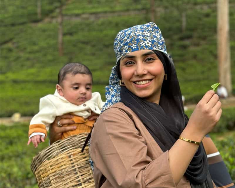 Pakistani woman with her baby in basket at a tea plantation in Nuwara Eliya, Sri Lanka